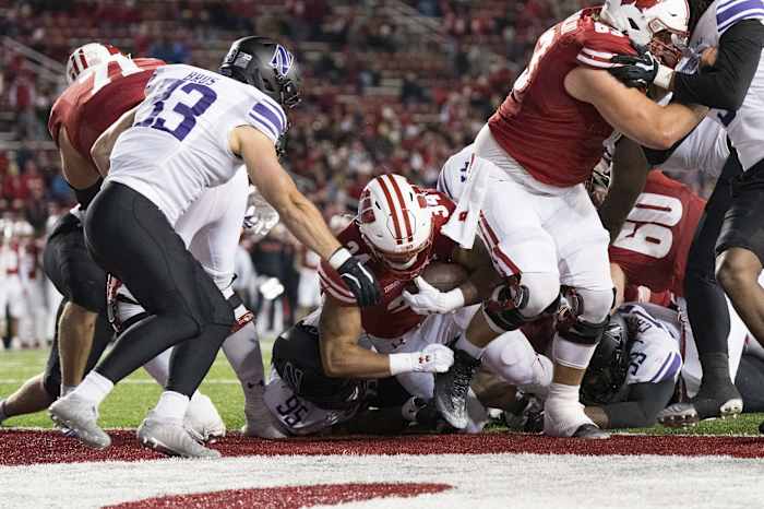 Nov 11, 2023; Madison, Wisconsin, USA; Wisconsin Badgers running back Jackson Acker (34) scores a touchdown during the fourth quarter against the Northwestern Wildcats at Camp Randall Stadium. Mandatory Credit: Jeff Hanisch-USA TODAY Sports